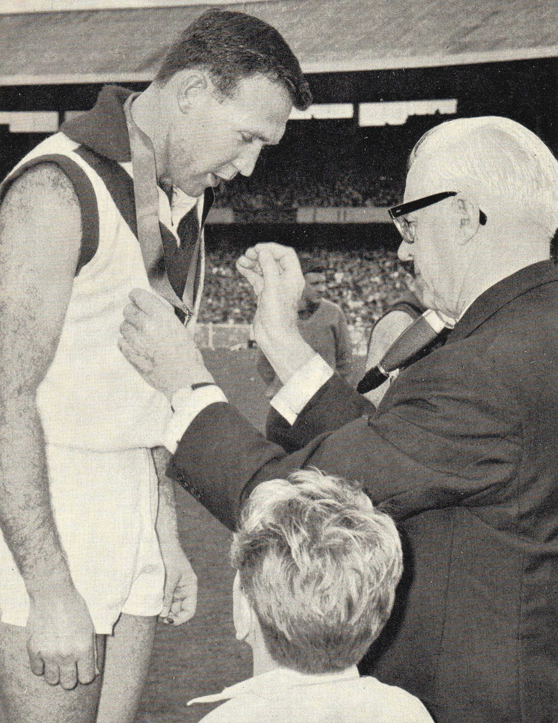 Bob Skilton being presented with a Brownlow Medal copy